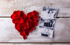 graphicstock-black-and-white-photos-of-a-romantic-senior-couple-laid-on-white-wooden-table-red-rose-petal-heart-valentines-day-composition_HuvCG4Sz-